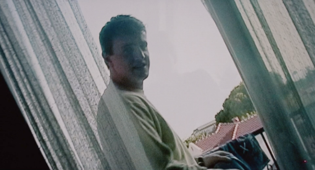 a man standing by the window, a grainy image